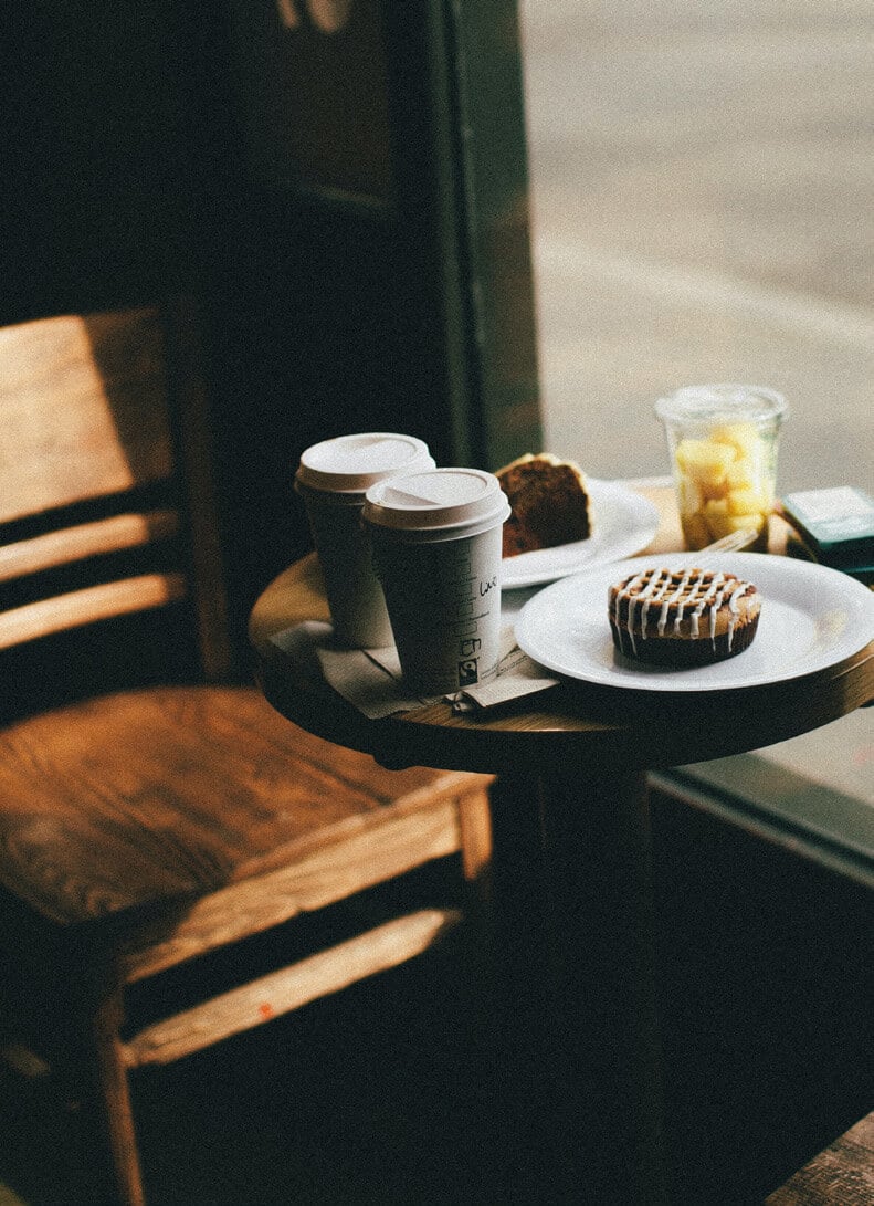 Coffee cup and pastry on wooden table
